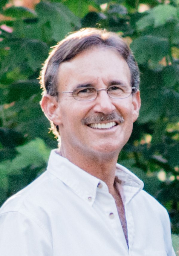 Headshot of Donald Telian against greenery